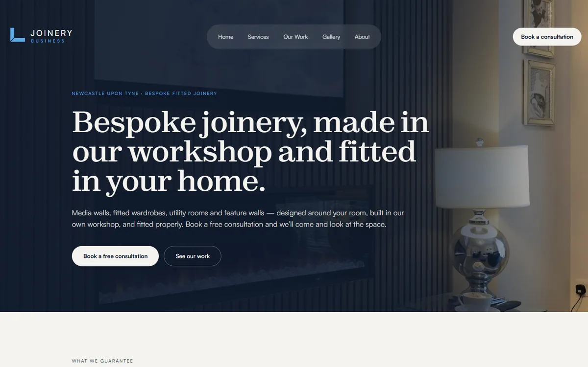 Joinery Business homepage: deep navy hero with a serif headline over a fitted media wall
